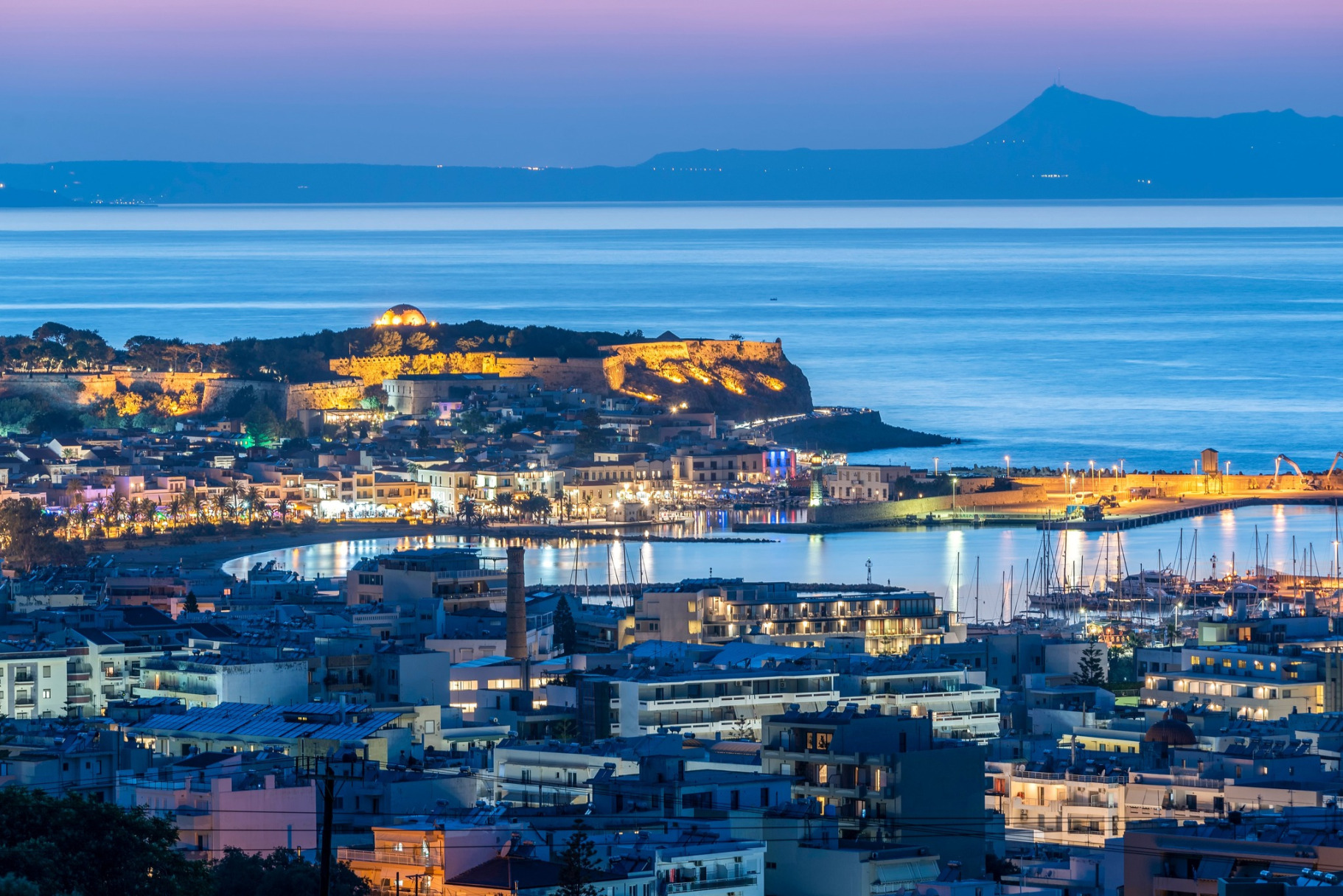 Rethymno city and Fortezza castle at sunset from above, Venetian Harbor, beach and sea